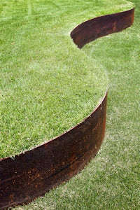 Core Edge Flexible Steel Lawn Edging show in CorTen edging shown bordering yard - Edge It Co by Henderson Supply